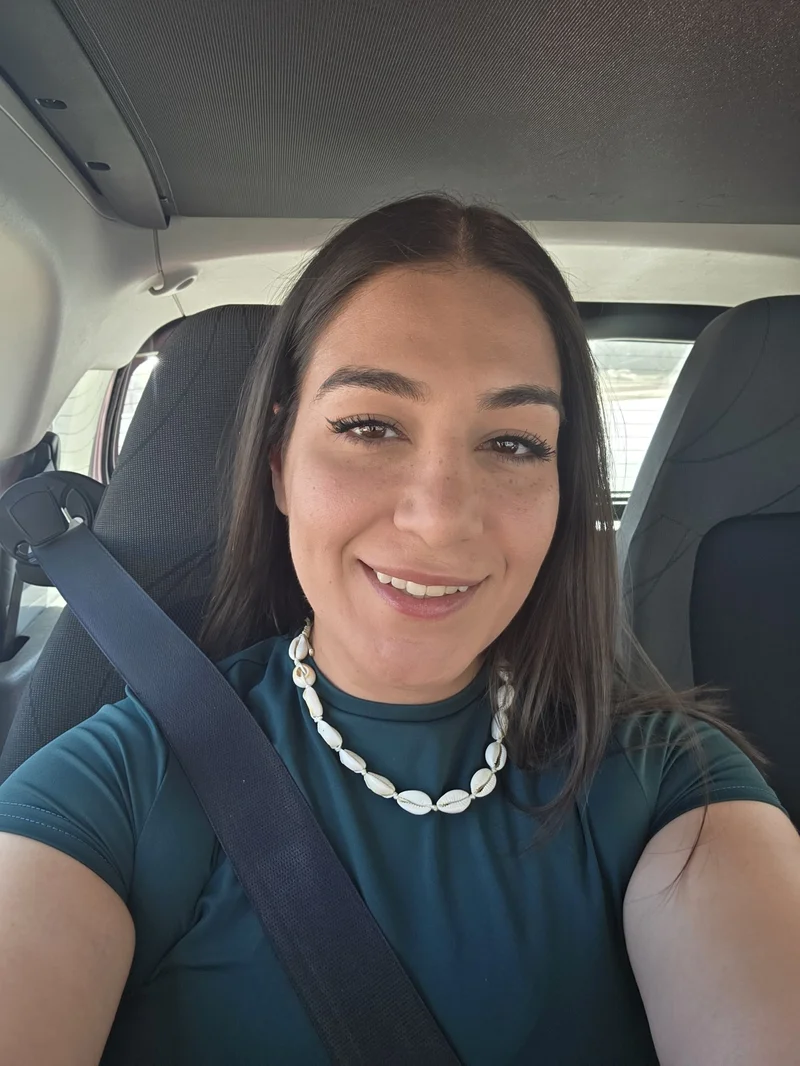 Smiling nutrition professional sitting in a car